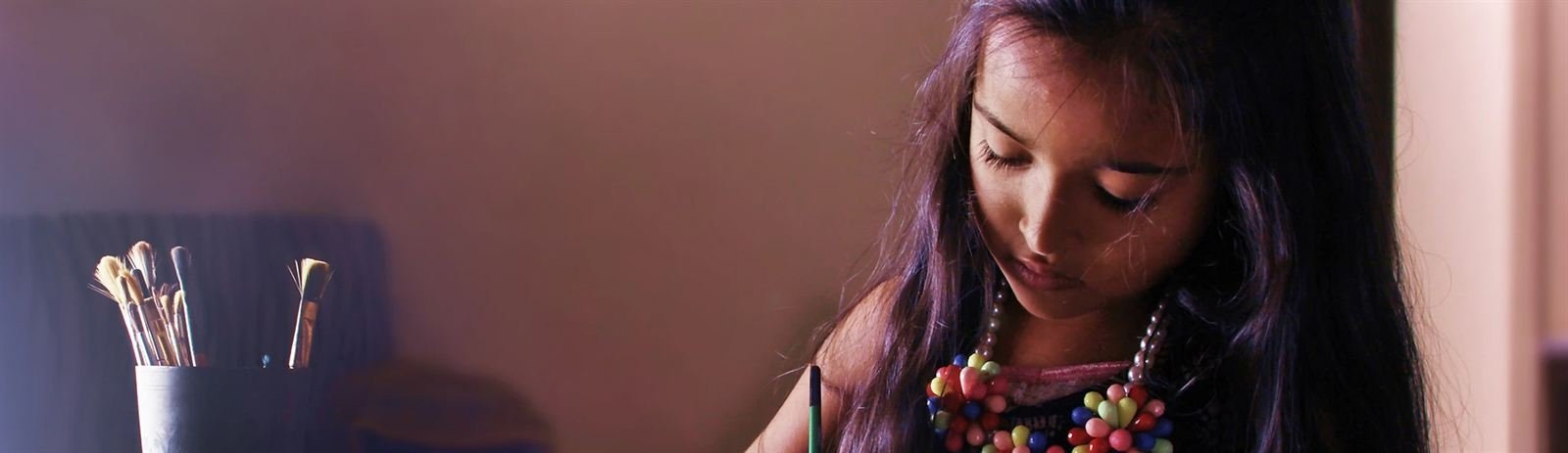 Girl painting on canvas